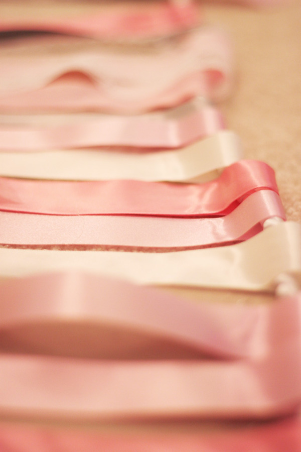 Pink and white ribbon around white cord