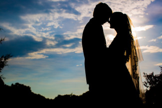 sunset silhouette of bride and groom