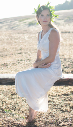 Model bride sits on wood fence
