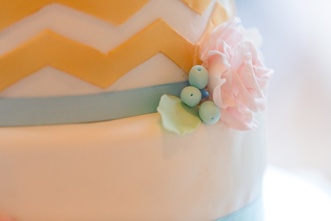 Close up of fondant rose and grapes on wedding cake