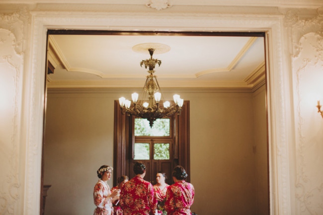 Bride with bridesmaids in bright colored robes getting ready at Cylburn Arboretum