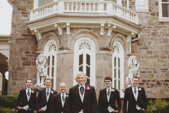 Groom and groomsmen standing in front of Cylburn Arboretum in formal morning coats 