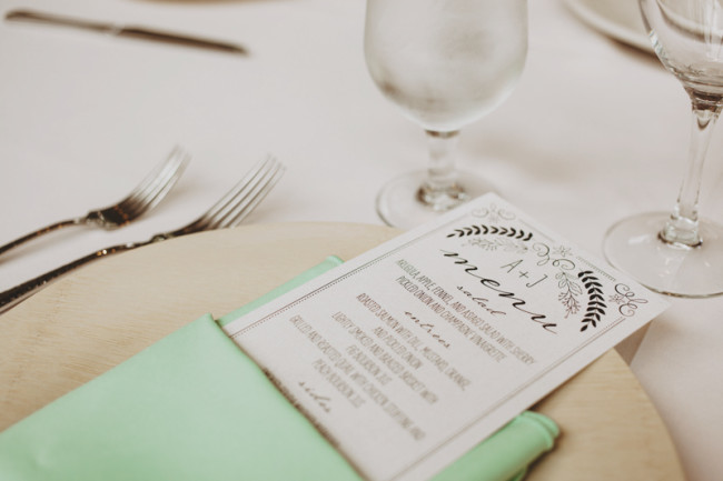 Wedding menus by wedding paper divas wrapped in mint green napkin