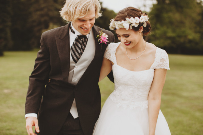 Groom in morning coat and bride wearing floral crown standing together after ceremony at Cylburn Arboretum
