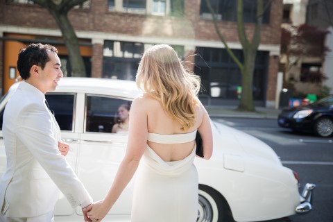 Bride and groom getting in to a ivory vintage car rented from British Motor Coach in Seattle