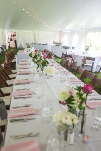 Rectangle wedding reception with white table cloth and pink napkins