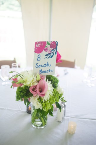 Green, white and pink flowrs in small clear jar for wedding receptin created by A Garden Party