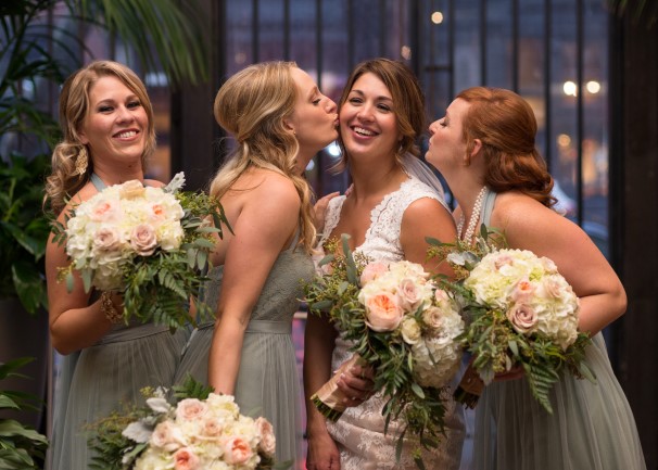Bride wearing lace gown standing with bridesmaids in mint green gowns captured by Lindsay Murphy Photography