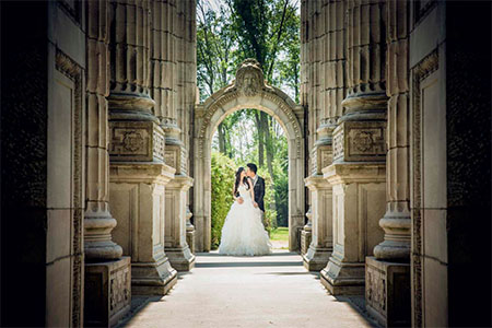 bride and groom surrounded by old columns