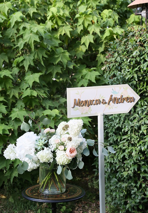 Wedding sign arrow with floral pattern and gold writing