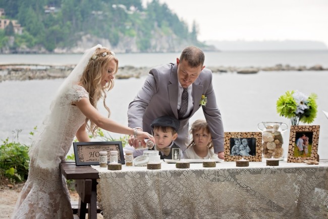 Bride an dgroom doing a sand ceremony outdoors on a beach
