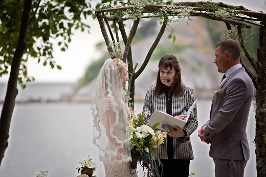 Bride and groom exchange vows during wedding at Whytecliff Park