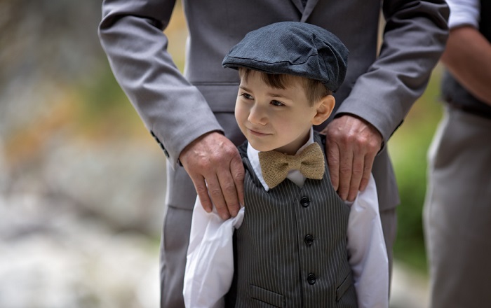 Ring bearer wearing burlap bow tie