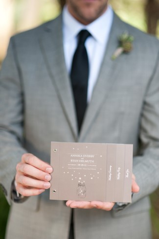 groom holding flipbook stationery