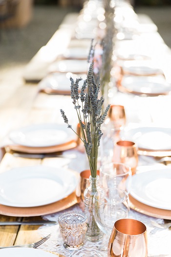 Wedding reception with lavender and copper mugs and lace table runner