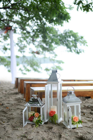 three wedding lanters on sandy beach