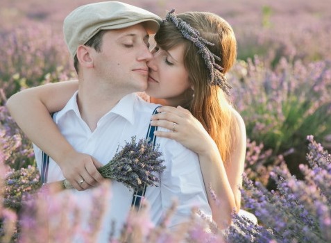 couple sit in a field of lavender