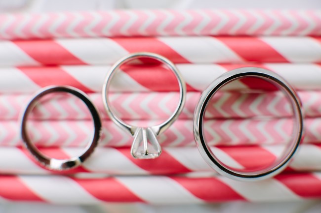 Drinking straws with wedding rings on top