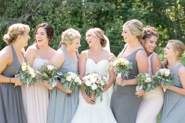 bridesmaids in different tones of dresses