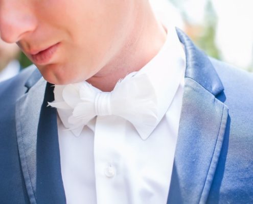 groom in white bow tie