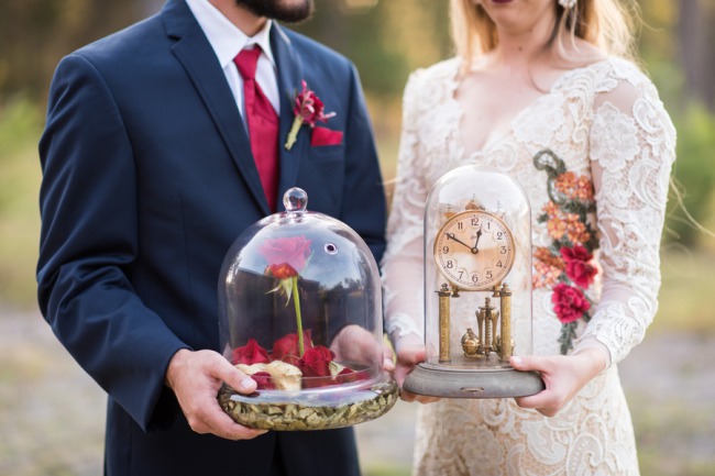 couple holding styled beauty and beast decor