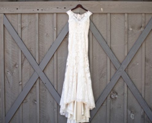 dress hanging against gray barn door