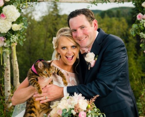 groom with bride holding pet cat
