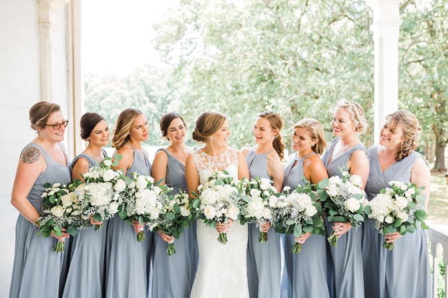 bridesmaids dusty-blue-gowns-matching-white-bouquets