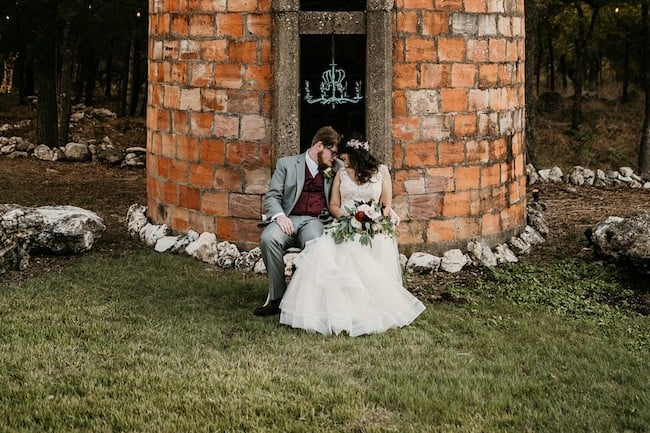 wedding day couple portrait with red brick background