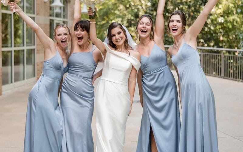 Woman in Wedding Dress with her Bridesmaids