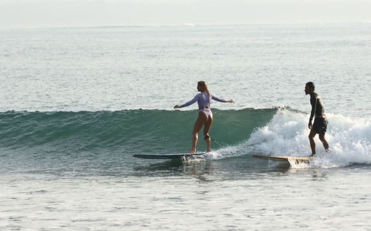 A boy and a girl surfing